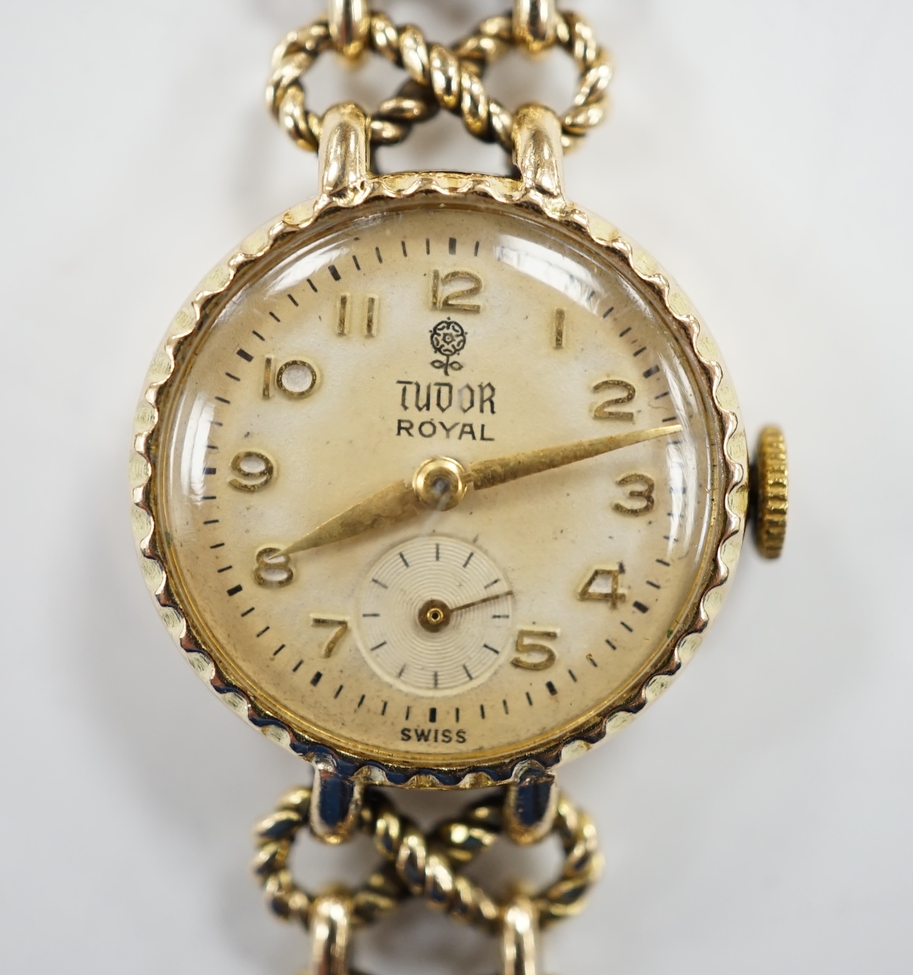 A lady's late 1950's 9ct gold Tudor Royal manual wind wrist watch, on a 9ct gold Rolex bracelet, overall 18.5cm, gross 22 grams, with Rolex box.